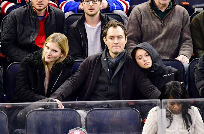 Pjhillipa Coan, Jude Law, and Iris Law at a sports game