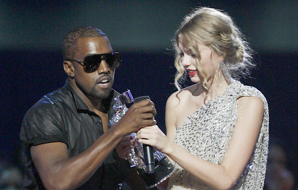 Singer Kanye West takes the microphone from singer Taylor Swift as she accepts the "Best Female Video" award during the MTV Video Music Awards on Sunday, Sept. 13, 2009 in New York.  (AP Photo/Jason DeCrow)