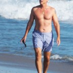 EXCLUSIVE: Rob Lowe takes his shirt off for a walk on the beach in Santa Barbara Sunday with friends.