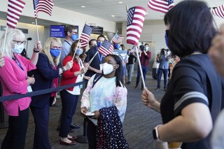 Simone Biles walks to her gate for her flight to the Summer Olympic Games in Tokyo as United Airlines employees wave flags during a send-off event for the U.S. Women's Gymnastics team at the San Francisco International Airport on
US Gymnastics Biles, San Francisco, United States - 14 Jul 2021