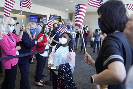 Simone Biles walks to her gate for her flight to the Summer Olympic Games in Tokyo as United Airlines employees wave flags during a send-off event for the U.S. Women's Gymnastics team at the San Francisco International Airport on
US Gymnastics Biles, San Francisco, United States - 14 Jul 2021