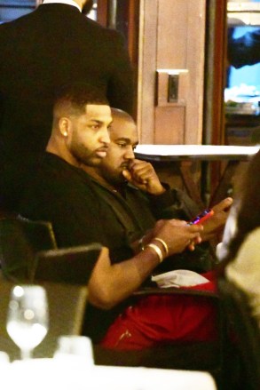 EXCLUSIVE: Kim Kardashian's ex Kanye West has dinner with Khloe Kardashain's ex Tristan Thompson in Miami. The dinner meeting was at the Ocean Grill beachside at the Setai Hotel and the two looked to be having a good time enjoying each others company. 01 Mar 2022 Pictured: Kanye West; Tristan Thompson. Photo credit: MEGA TheMegaAgency.com +1 888 505 6342 (Mega Agency TagID: MEGA833296_001.jpg) [Photo via Mega Agency]