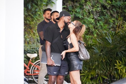 EXCLUSIVE: Sealed with a kiss! Larsa Pippen and Marcus Jordan confirm their romance is ON as they share a smooch in Miami Beach. Until now, the 48-year-old 'Real Housewives of Miami' star has been coy about her relationship with the son of NBA legend Michael Jordan. But it looks like she and the 32-year-old are officially a couple, after a cute PDA outside the upscale W South Beach hotel on Saturday. They held hands and were all smiles as they left the beachfront venue, with Larsa showing off her famous curves in a black Jean Paul Gaultier bodysuit with racy leather hot pants and Chanel slides. Her beau, who slung his arm around her shoulders as they waited for their car, was casual in all black and carried his laptop bearing the famous Jordan logo. The much talked about duo certainly appeared to be cosy and relaxed in each other's company amid swirling speculation about their romance. 07 Jan 2023 Pictured: Larsa Pippen, Marcus Jordan. Photo credit: Romain Maurice/MEGA TheMegaAgency.com +1 888 505 6342 (Mega Agency TagID: MEGA930855_001.jpg) [Photo via Mega Agency]