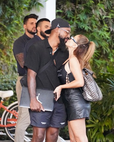 EXCLUSIVE: Sealed with a kiss! Larsa Pippen and Marcus Jordan confirm their romance is ON as they share a smooch in Miami Beach. Until now, the 48-year-old 'Real Housewives of Miami' star has been coy about her relationship with the son of NBA legend Michael Jordan. But it looks like she and the 32-year-old are officially a couple, after a cute PDA outside the upscale W South Beach hotel on Saturday. They held hands and were all smiles as they left the beachfront venue, with Larsa showing off her famous curves in a black Jean Paul Gaultier bodysuit with racy leather hot pants and Chanel slides. Her beau, who slung his arm around her shoulders as they waited for their car, was casual in all black and carried his laptop bearing the famous Jordan logo. The much talked about duo certainly appeared to be cosy and relaxed in each other's company amid swirling speculation about their romance. 07 Jan 2023 Pictured: Larsa Pippen, Marcus Jordan. Photo credit: Romain Maurice/MEGA TheMegaAgency.com +1 888 505 6342 (Mega Agency TagID: MEGA930855_001.jpg) [Photo via Mega Agency]