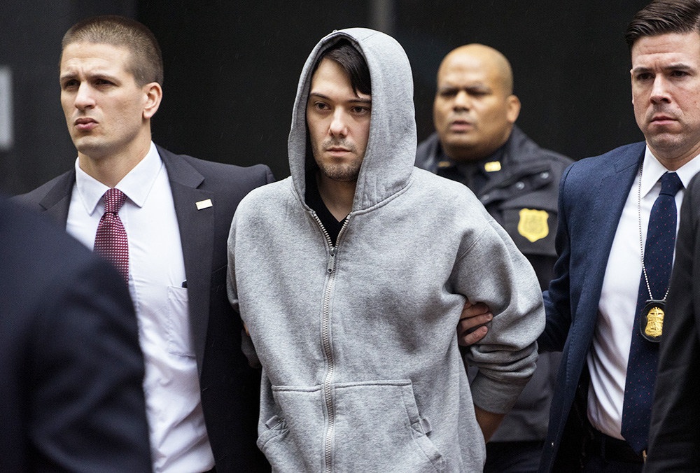 FILE - In this Thursday, Dec. 17, 2015, file photo, Martin Shkreli, center, the former hedge fund manager under fire for buying a pharmaceutical company and ratcheting up the price of a life-saving drug, is escorted by law enforcement agents in New York  after being taken into custody following a securities probe. U.S. Rep. Elijah Cummings, D-Maryland, said a lawyer for Shkreli indicated he has not sought permission from a New York judge to appear at a congressional hearing Tuesday, Jan. 26, 2016, on drug prices, despite receiving a subpoena. (AP Photo/Craig Ruttle, File)