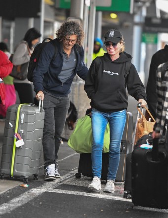 New York, NY  - *EXCLUSIVE*  - Canadian country singer Shania Twain lands at JFK airport with her husband Frédéric Thiébaud. The couple recently celebrated their 12-year anniversary.

Pictured: Shania Twain, Frédéric Thiébaud

BACKGRID USA 3 JANUARY 2023 

USA: +1 310 798 9111 / usasales@backgrid.com

UK: +44 208 344 2007 / uksales@backgrid.com

*UK Clients - Pictures Containing Children
Please Pixelate Face Prior To Publication*