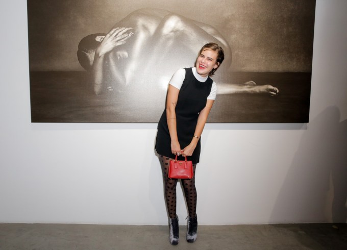 Tallulah Willis gives a cheeky smile at an art exhibit