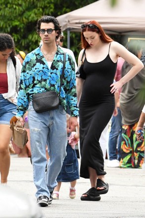 EXCLUSIVE: Sophie Turner shows off her growing baby bump in a tight maxi dress as she and husband Joe Jonas hit up a crowded farmers market in Miami. Joe showed off is unique sense of style in a bright floral shirt, painted nails, and a leather bag. 03 Apr 2022 Pictured: Joe Jonas, Sophie Turner. Photo credit: MEGA TheMegaAgency.com +1 888 505 6342 (Mega Agency TagID: MEGA844412_001.jpg) [Photo via Mega Agency]
