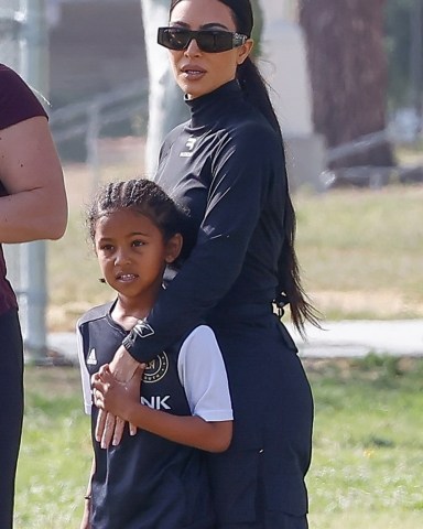 Los Angeles, CA  - Kim Kardashian keeps her arm around her boy Saint during his Sunday soccer game today.  Kim continues to be the doting soccer mom cheering on Saint every game.  Pictured: Kim Kardashian, Saint West  BACKGRID USA 10 APRIL 2022   USA: +1 310 798 9111 / usasales@backgrid.com  UK: +44 208 344 2007 / uksales@backgrid.com  *UK Clients - Pictures Containing Children Please Pixelate Face Prior To Publication*