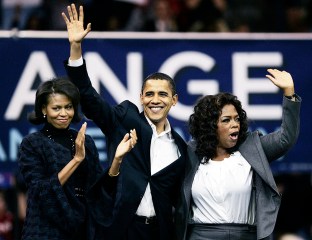 Democratic presidential hopeful, Sen. Barack Obama, D-Ill., his wife Michelle, left, and Oprah Winfrey wave to the crowd at the end of a rally in Manchester, N.H. Sunday, Dec. 9, 2007. (AP Photo/Elise Amendola)