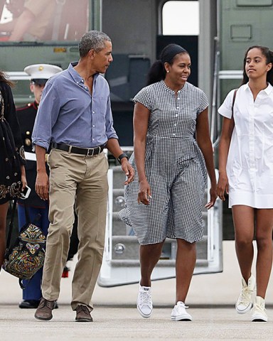 Barack Obama, Michelle Obama, Malia Obama, Sasha Obama President Barack Obama with first lady Michelle Obama and their daughters Malia, right, and Sasha walk on the tarmac to board Air Force One at Air Station Cape Cod in Mass., . Obama is returning from vacation rested and ready for a busy fall, including pressing Congress for money to protect against the Zika virus and fending off lawmakers' attacks over the administration's $400 million "leverage" payment to Iran
Barack Obama and family return from vacation, Cape Cod, USA - 21 Aug 2016