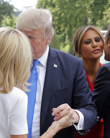 MAXPPP OUT Mandatory Credit: Photo by MICHEL EULER/POOL/EPA/REX/Shutterstock (8960077h) Emmanuel Macron, Melania Trump, Brigitte Macron and Donald J. Trump Donald J. Trump's visit to Paris, France - 13 Jul 2017 French President Emmanuel Macron (R) welcomes First Lady Melania Trump (2-R) while his wife Brigitte (L) welcomes US President Donald J. Trump at Les Invalides museum in Paris, France, 13 July 2017. President Trump and French President Macron planned to meet 13 July in Paris to focus on issues where they can take US-French relations forward, with major security and defense topics among them.