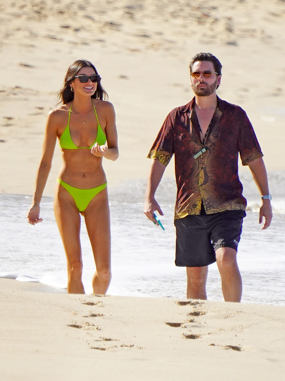 Scott Disick and a mystery brunette girl strolling one the beach during holidays season in St-Barts