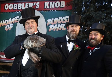 Groundhog Club co-handler John Griffiths (L) holds Phil the weather prognosticating groundhog as co-handler AJ Dereume (C) and groundhog club member Patrick Osikowicz (R) look on during the Groundhog Day celebration at Gobblers Knob in Punxsutawney, Pennsylvania, USA , 02 February 2018. Phil saw his shadow and predicted six more weeks of winter.  Punxsutawney Phil predicts the Weather on Groundhog Day, USA - 02 Feb 2018