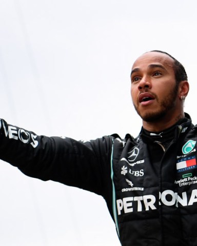 Mercedes driver Lewis Hamilton of Britain celebrates after winning the Turkish Formula One Grand Prix at the Istanbul Park circuit racetrack in Istanbul, Sunday, Nov. 15, 2020. (Clive Mason/Pool via AP)