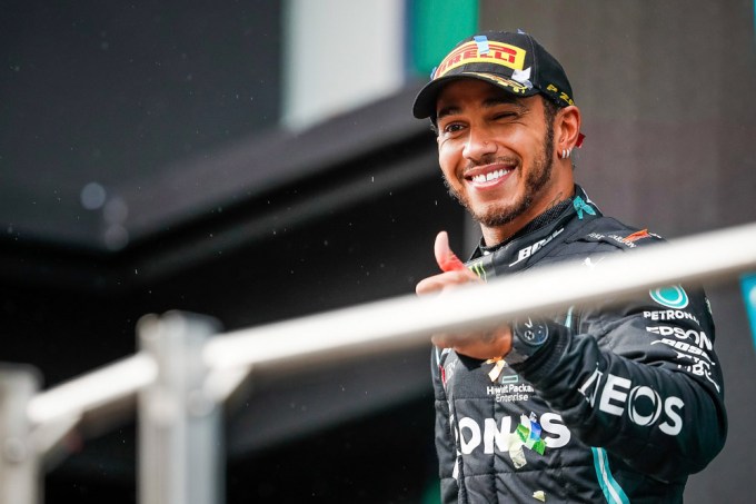 Lewis Hamilton smiles for the cameras