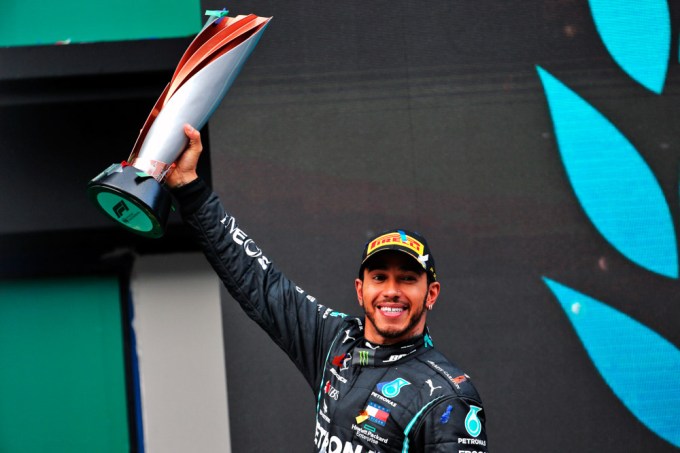Lewis Hamilton holds his championship trophy