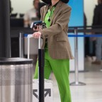 *EXCLUSIVE* Dua Lipa shows off her lime green suit while catching a flight at JFK in New York