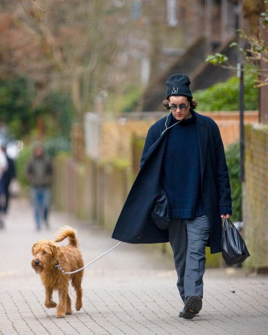 EXCLUSIVE: Matt Smith looks stylish as he walks his Irish Terrier Dog called Bobby in North London. 31 Jan 2022 Pictured: Matt Smith. Photo credit: MEGA TheMegaAgency.com +1 888 505 6342 (Mega Agency TagID: MEGA824178_002.jpg) [Photo via Mega Agency]