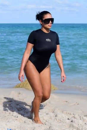 Kanye West's new girlfriend Chaney Jones hits the beach in a Balenciaga swimsuit after a shopping spree with the rapper in Miami. It wasn't too long ago on this very same beach that ex-girlfriend Julia Fox wore the same Balenciaga design, except hers said Miami while Chaney's says Paris. 26 Feb 2022 Pictured: Chaney Jones. Photo credit: MEGA TheMegaAgency.com +1 888 505 6342 (Mega Agency TagID: MEGA832021_003.jpg) [Photo via Mega Agency]
