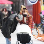 New parents Gigi Hadid and Zayn Malik take their baby daughter for a stroll