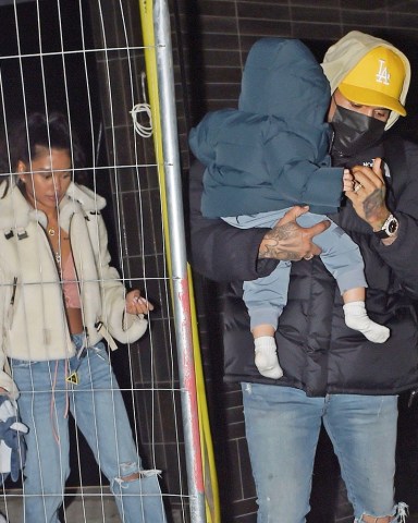 London, UNITED KINGDOM  - *EXCLUSIVE*  - R&B star Chris Brown plays the doting father, as he holds his baby son Aeko with baby mother Ammika Harris following behind, holding a baby bottle.Chris looked casual wearing his North Face jacket, yellow cap, jeans and his protective face mask as he showed off some bling with his flash designer watch. The British singer Rita Ora was also spotted looking a little inconspicuous wearing her black PVC puffer jacket and designer Chanel handbag trying to hide from the cameras and also showing off her wealth, with her hands full of gold rings on each finger as the gang left separately from a venue in London's Soho.Pictured: Chris Brown - Ammika HarrisBACKGRID USA 14 OCTOBER 2020 BYLINE MUST READ: SOUTHPAW / BACKGRIDUSA: +1 310 798 9111 / usasales@backgrid.comUK: +44 208 344 2007 / uksales@backgrid.com*UK Clients - Pictures Containing ChildrenPlease Pixelate Face Prior To Publication*
