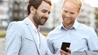 Men Laughing At Cellphone