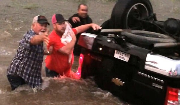 Rescuer Tries To Save Baby From Texas Flood