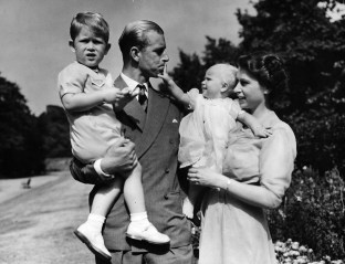 Britain's Queen Elizabeth II, then Princess Elizabeth, stands with her husband Prince Philip, the Duke of Edinburgh, and their children Prince Charles and Princess Anne at Clarence House, the royal couple's London residence, in this August 1951 file photo. The Queen celebrates her 80th birthday on April 21, 2006. (AP Photo/Eddie Worth)