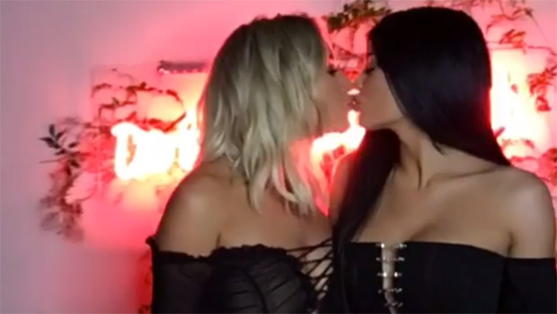 Kylie Jenner and Stassie Karanikolaou share a sweet, friendly kiss in a bir...
