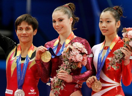 USA's McKayla Maroney, center, is flanked by silver medalist Germany's Oksana Chusovitina, left, and bronze medalist Vietnam's Thi Ha Thanh Phan, right, after winning the gold medal during the final of the women's vaulting table at the Artistic Gymnastics World Championships in Tokyo, Japan
Japan World Gymnastics, Tokyo, Japan