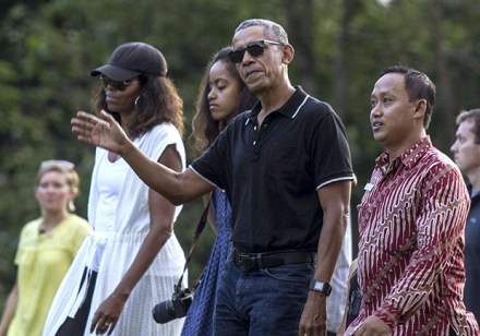 Former U.S. President Barack Obama, center, waves as he walks with his wife Michelle, left, and daughter Malia, rear, upon arrival for a tour at Borobudur Temple in Magelang, Central Java, Indonesia, . Obama and his family wrapped up their five-day vacation on Indonesia's resort island of Bali and headed to the historic city of Yogyakarta on Wednesday during a nostalgic trip to the country where Obama lived for several years as a childObama, Magelang, Indonesia - 28 Jun 2017