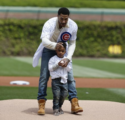 PJ Rose, Derrick Rose PJ Rose gets some final pointers from his dad Derrick Rose before throwing at the first pitch at Wrigley Field before a baseball game between the Pittsburgh Pirates and the Chicago Cubs, in ChicagoPirates Cubs Baseball, Chicago, USA