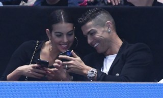 Juventus' Portuguese forward Cristiano Ronaldo (R) shares a joke with Georgina Rodriguez (L)  as they watch the game between US player John Isner against Serbia's Novak Djokovic during their men's singles round-robin match on day two of the ATP World Tour Finals tennis tournament at the O2 Arena in London, Britain, 12  November 2018.
ATP Tour Finals Tennis, London, United Kingdom - 12 Nov 2018