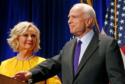 FILE - In this Tuesday, Nov. 8, 2016, file photo, Sen. John McCain, R-Ariz., right, pauses as his wife, Cindy McCain, looks at him on stage after giving his victory speech as he announces his win over Democratic challenger Rep. Ann Kirkpatrick, in Phoenix. The family of the late Sen. John McCain says they want to build a library on land donated by Arizona State University to house his archives and provide a “gathering place” for respectful dialogue. (AP Photo/Ross D. Franklin, File)