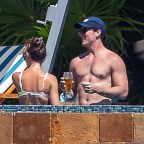 Top Gun star Miles Teller goes shirtless as he soaks up the sun and cuddles his model wife Keleigh Sperry during a lavish getaway to Mexico