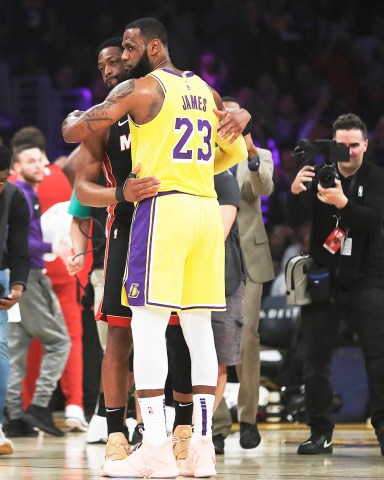Los Angeles Lakers forward LeBron James (23) hugs ex teammate and current Miami Heat player Dwyane Wade during the first half of an NBA basketball game Monday, Dec. 10, 2018, in Los Angeles. (AP Photo/Marcio Jose Sanchez)