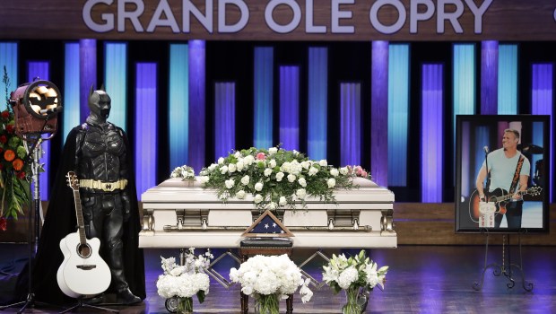 A Batman costume and guitar appear next to the casket during a memorial service for country music singer Troy Gentry at the Grand Ole Opry House, in Nashville, Tenn. Gentry, who was a fan of Batman and made up the duo Montgomery Gentry with Eddie Montgomery, died Sept. 8 in a helicopter crash
Troy Gentry Memorial, Nashville, USA - 14 Sep 2017