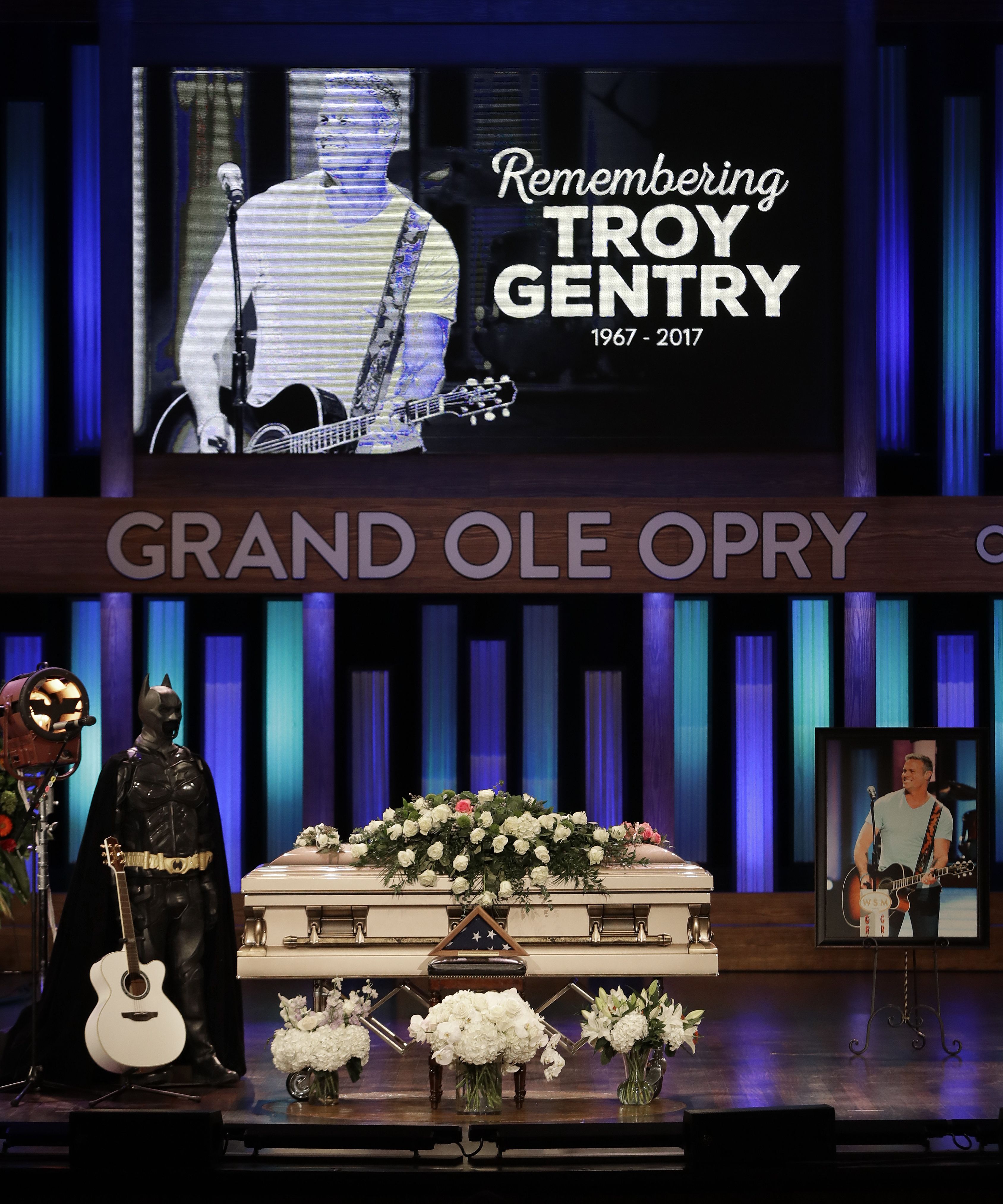 A Batman costume and guitar appear next to the casket during a memorial service for country music singer Troy Gentry at the Grand Ole Opry House, in Nashville, Tenn. Gentry, who was a fan of Batman and made up the duo Montgomery Gentry with Eddie Montgomery, died Sept. 8 in a helicopter crash
Troy Gentry Memorial, Nashville, USA - 14 Sep 2017