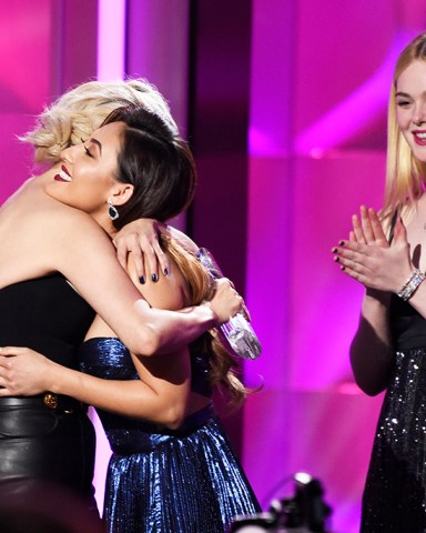 Presenter Francia Raisa, center, hugs woman of the year award winner Selena Gomez, left, as presenter Elle Fanning looks on at the Billboard Women in Music event at the Ray Dolby Ballroom on Thursday, Nov. 30, 2017, in Los Angeles. (Photo by Chris Pizzello/Invision/AP)