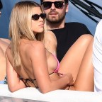 Sofia Richie shows off her voluptuous curves in a hot pink bikini as she takes a ride on a yacht with boyfriend Scott Disick in Miami