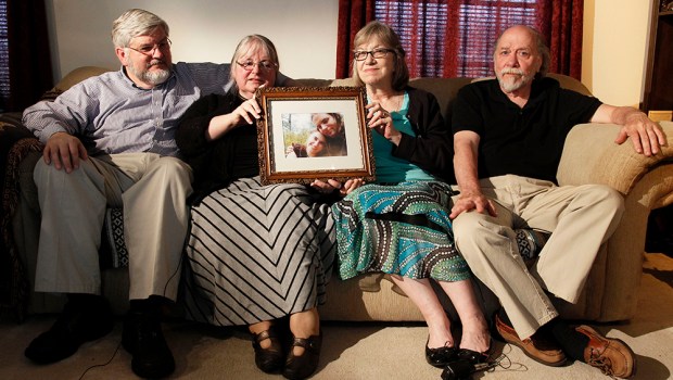 From left, Patrick Boyle, Linda Boyle, Lyn Coleman and Jim Coleman hold photo of their kidnapped children, Joshua Boyle and Caitlan Coleman, who were taken by the Taliban in late 2012, Wednesday, June 4, 2014, in Stewartstown, Pa. The family of a pregnant American woman who went missing in Afghanistan in late 2012 with her Canadian husband received two videos last year in which the couple asked the U.S. government to help free them and their child from Taliban captors, The Associated Press has learned. (AP Photo/Bill Gorman)