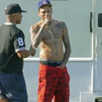 Chris Brown shows his regained fit body as he rests his hand inside his Shorts