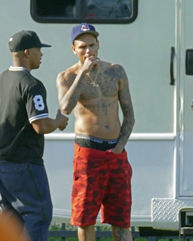 American hip-hop / r&b / pop singer Chris Brown was pictured shirtless while on break from filming a music video with DJ Khaled, August Alsina, Fetty Wap, and other artists, models, and friends. His regained fit body can be seen as he shed the extra weight that he put on a while back. His hand was also resting inside the crotch area of his shorts.Pictured: Chris BrownRef: SPL1115927 020915 NON-EXCLUSIVEPicture by: SplashNews.comSplash News and PicturesLos Angeles: 310-821-2666New York: 212-619-2666London: +44 (0)20 7644 7656Berlin: +49 175 3764 166photodesk@splashnews.comWorld Rights