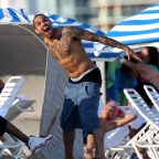 Chris Brown shirtless playing with seagulls at the beach in Miami