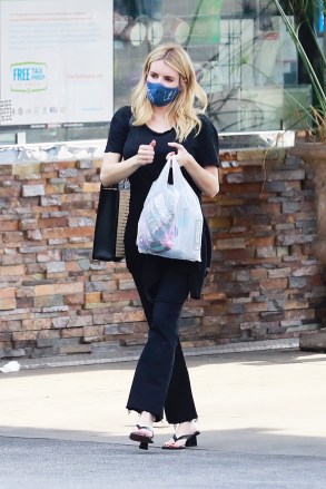 Actress Emma Roberts wears an all-black outfit consisting of a