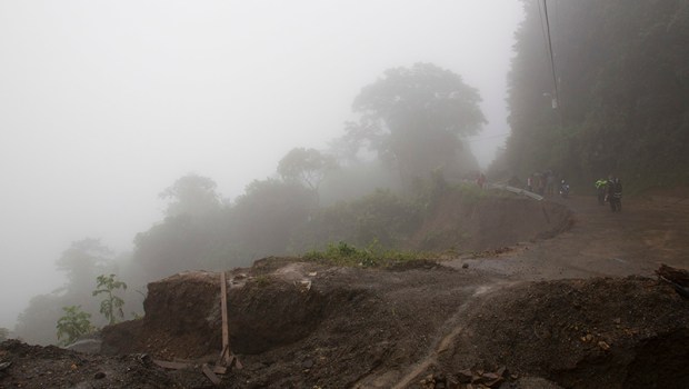 Neighbors walk under the rain past a washed out road in Alajuelita on the outskirts of San Jose, Costa Rica, Thursday, Oct. 5, 2017. Tropical Storm Nate formed off the coast of Nicaragua on Thursday and was being blamed for at least 17 deaths in Central America as it spun north toward a potential landfall on the U.S. Gulf Coast as a hurricane over the weekend. (AP Photo/Moises Castillo)