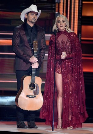 Hosts Brad Paisley, left, and Carrie Underwood appear during the opening of the 51st annual CMA Awards at the Bridgestone Arena on Wednesday, Nov. 8, 2017, in Nashville, Tenn. (Photo by Chris Pizzello/Invision/AP)