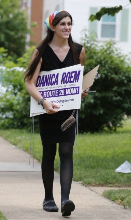 Democratic nominee for the House of Delegates 13th district seat, Danica Roem, brings campaign signs as she greets voters while canvasing a neighborhood, in Manassas, Va. Roem is running against Del. Bob Marshall in the 13th House of Delegates District
House Race Transgender Candidate, Manassas, USA - 21 Jun 2017