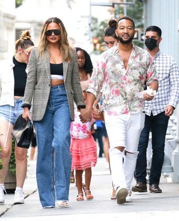 John Legend was spotted holding a hotdog with one hand and on the other hand holds wife Chrissy Teigen while they take a stroll in New York City on Aug 19, 2021Pictured: John Legend and Chrissy TeigenRef: SPL5279016 190821 NON-EXCLUSIVEPicture by: Felipe Ramales / SplashNews.comSplash News and PicturesUSA: +1 310-525-5808London: +44 (0)20 8126 1009Berlin: +49 175 3764 166photodesk@splashnews.comWorld Rights